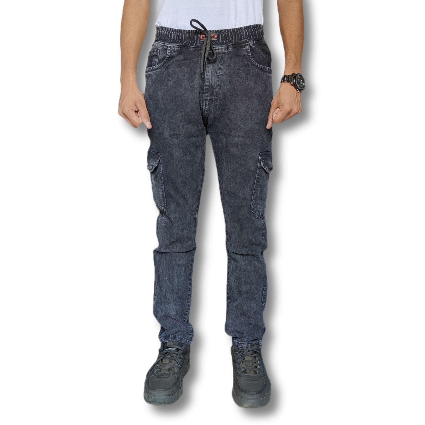 Person wearing dark gray cargo pants on a white background